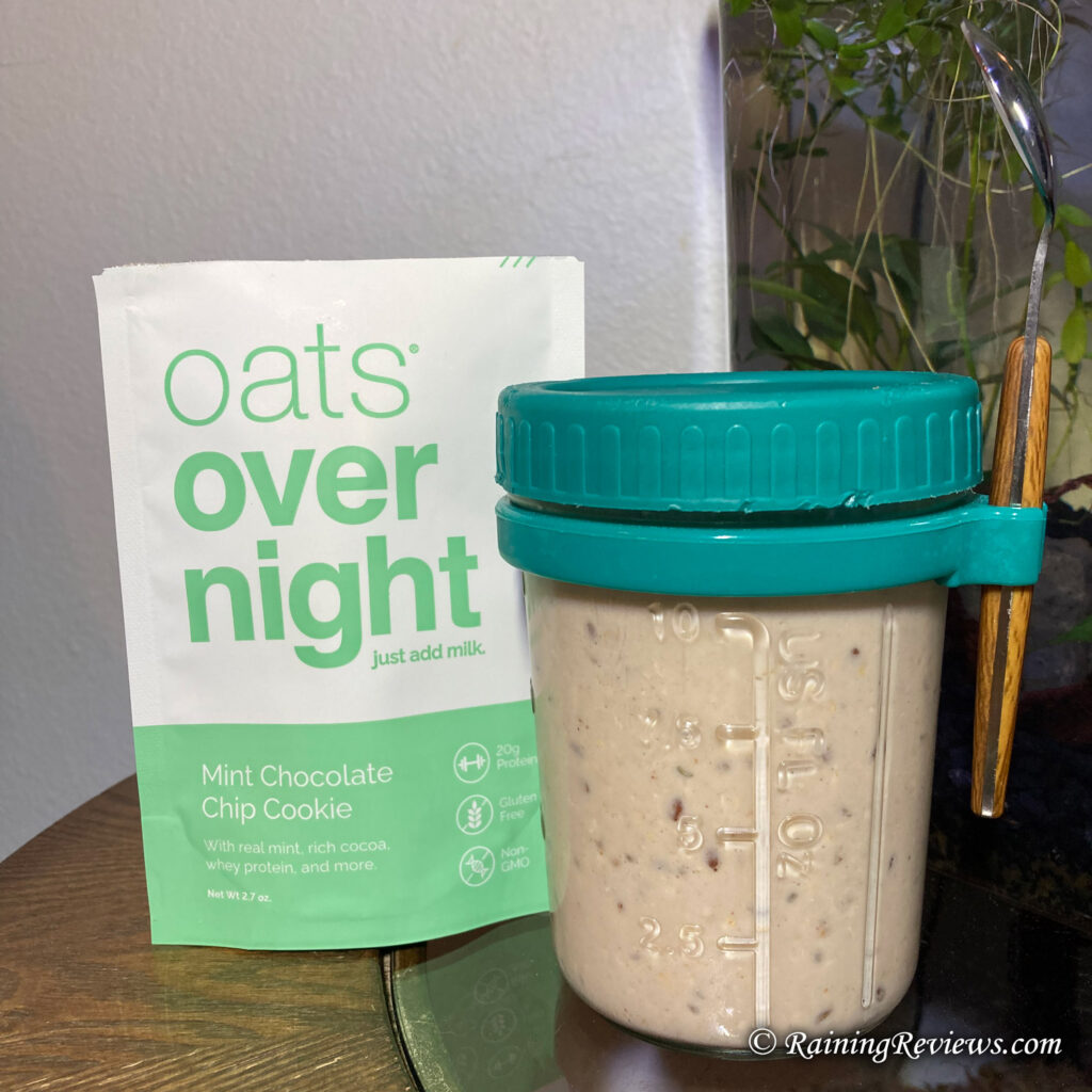 Mint Chocolate Chip Oats Overnight in a 16 ounce glass jar with a teal lid and spoon.